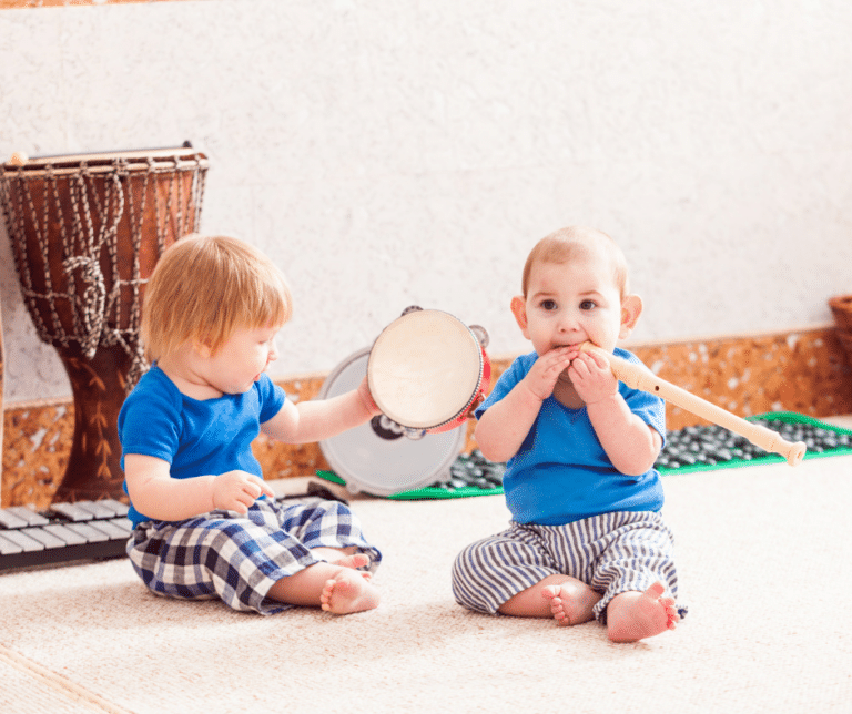 2 kids playing with musical instruments