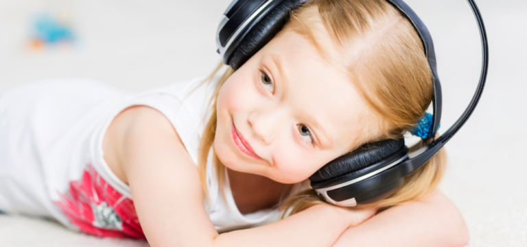 child listening to calming music on headphones