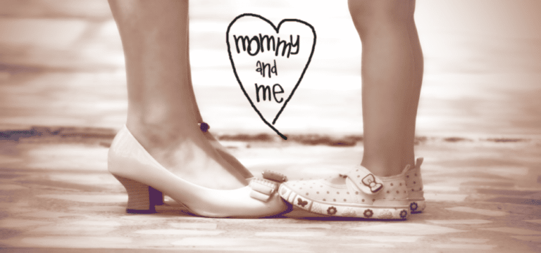 child standing on mommy shoes with mommy and me caption in black and white