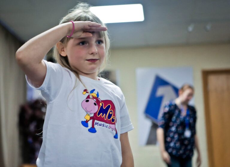 Young girl saluting in a Maggie Moo Music class
